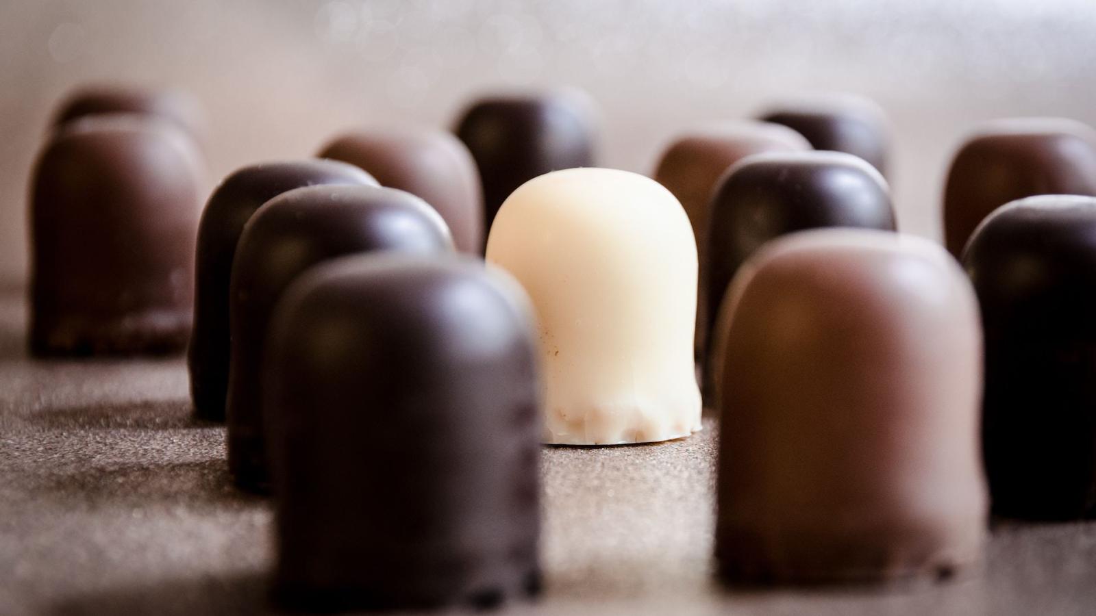 Assorted chocolates arranged on a neutral surface.